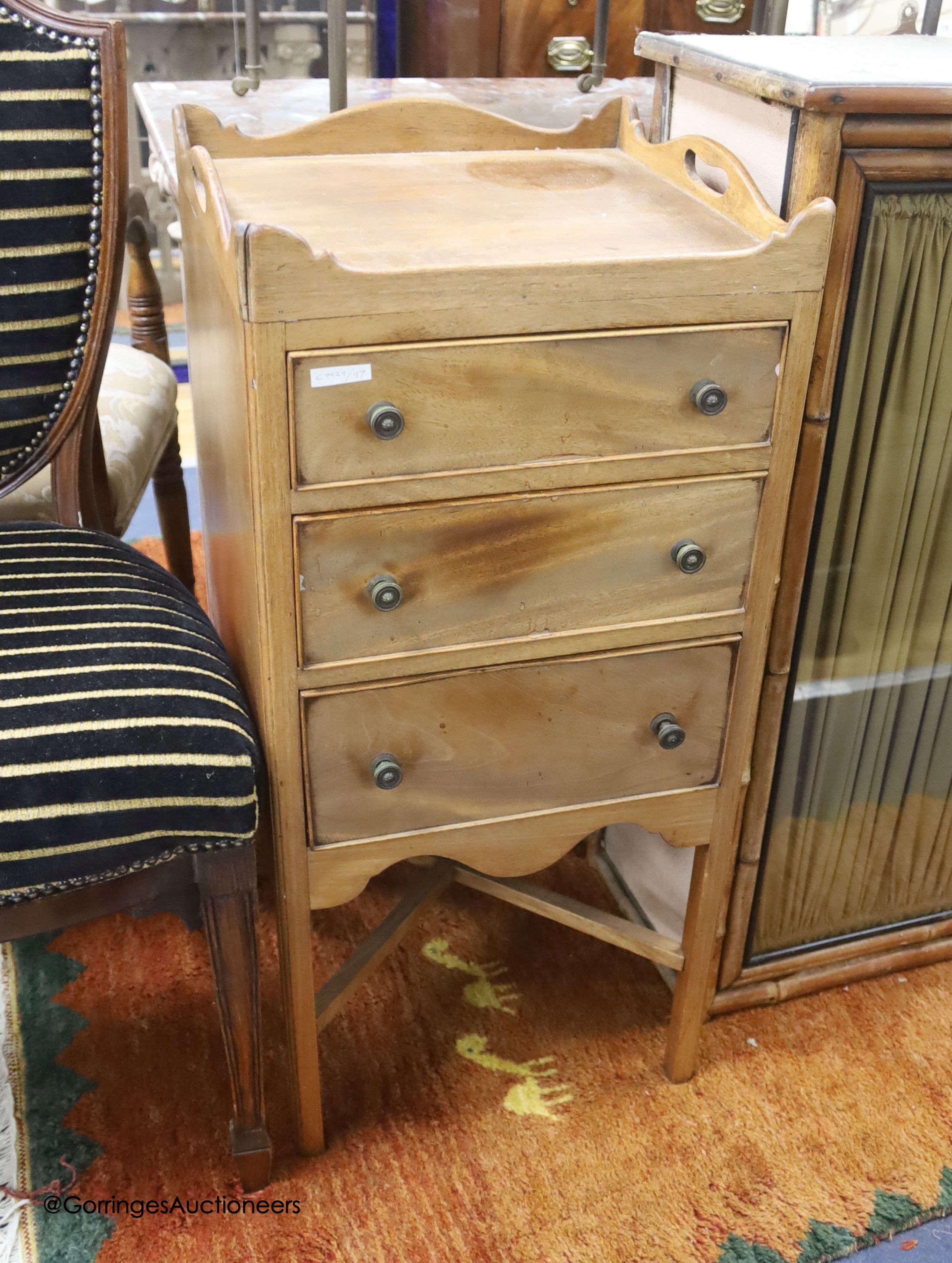 An early 19th century mahogany bedside chest of three drawers